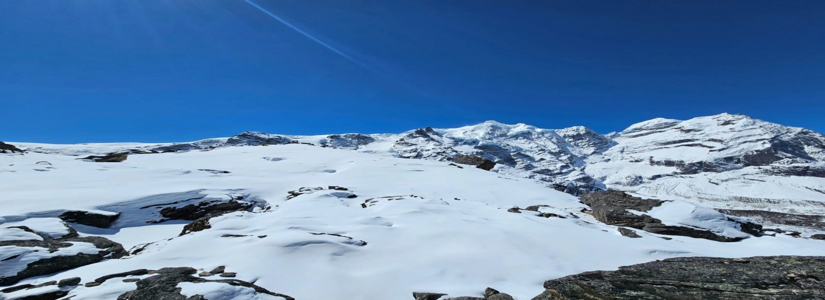 Langtang Valley Trekking route through  snowy landscape with Langtang Lirung mountain backdrop.